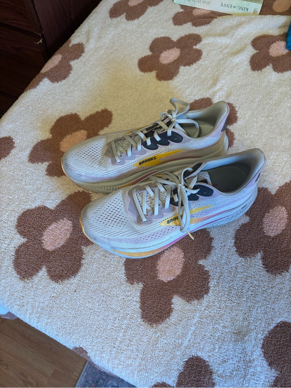 Brooks running shoes in light gray with yellow and pastel pink accents